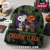Snoopy Halloween 2026 Beanie Hat in olive green tie-dye with mummy Snoopy and Woodstock embroidery and orange text.