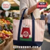 Pink and white striped canvas tote bag featuring an embroidered Snoopy on a red doghouse with Trader Joe's logo.!