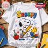 White cotton t-shirt featuring Snoopy holding a pencil, Woodstock holding a book, a red apple, and colorful school doodles.!