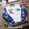 White and blue Sonic the Hedgehog 35th anniversary varsity jacket with striped cuffs on a wooden surface.!