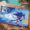 Sonic the Hedgehog 35th anniversary rectangular blue beach towel with Sonic running graphic and text on wooden deck.!