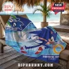 Sonic the Hedgehog plush beach towel with 35th anniversary text, blue and white design on a wooden lounge chair.!