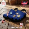 Blue foam clogs featuring Sonic the Hedgehog character charms on a wooden floor background.!