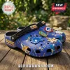 Blue Sonic the Hedgehog foam clogs with rubber charms of Sonic, Tails, and golden rings on a wooden deck background.!