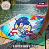 Sonic the Hedgehog 35th anniversary beach towel with vibrant blue, yellow, and green geometric patterns on a wooden dock.!