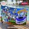 Sonic the Hedgehog 35th Anniversary beach towel with blue character graphics, gold rings, and a race car on a pool deck.!