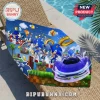 Sonic the Hedgehog beach towel featuring various game character iterations, golden rings, and a blue sports car on grass.!
