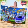 Sonic the Hedgehog 35th anniversary beach towel with multiple Sonic iterations, golden rings, and a blue sports car graphic.!