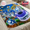 Sonic the Hedgehog fleece throw blanket featuring multiple Sonic characters, gold rings, and a blue racing car on a bed.!