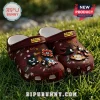 Maroon Sonic the Hedgehog anniversary clogs featuring rubber character charms resting on green grass.!