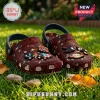 Maroon clog shoes featuring Shadow the Hedgehog character charms on a green grass background.!