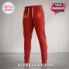 Spain National Football Team 2026 World Cup Champions joggers in red with vertical yellow pinstripes and team crest.