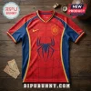 Red and blue Spider-Man themed soccer jersey with Spain national crest and spider web graphic on wooden background.!