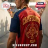 Spain National Team 2026 World Cup Champions football jersey in red and navy with gold lettering and laurel trophy graphic.