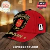 Spain National Team 2026 World Cup Champions red and black baseball cap with front crest embroidery on a wooden table.