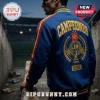 Spain National Team 2026 World Cup Champions varsity jacket in blue with gold and red back embroidery at a stadium tunnel.