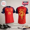 Spain World Cup Champions 2026 Signed Edition football jersey displaying red and blue colors, player number 26, and trophy.