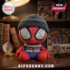 Spider-Man Brand New Day Beanie Plush Toy wearing a grey ribbed knit cap with holographic eye lenses on a desk.