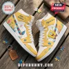High-top sneakers featuring yellow leather panels, Spongebob Squarepants graphics, and puzzle piece patterns on white base.!