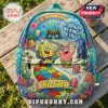 Light blue Spongebob Squarepants backpack featuring a puzzle piece path, rainbow, and text reading Be Bright, Be Kind.!