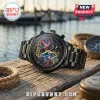 Black stainless steel Star Wars 50th anniversary watch with character art dial and gold hands on a wooden dock background.!