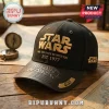 Star Wars Collector Edition Gold Logo Baseball Cap in black with gold embroidery, featuring 1977 text on a wooden desk.