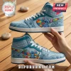 Blue high-top sneakers with Stitch character, puzzle piece hearts, palm trees, and Different Not Less text on wood table.!