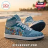 Light blue high-top sneakers featuring Stitch, tropical hibiscus flowers, puzzle piece patterns, and text Different, Not Less.!