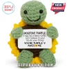Crocheted green turtle plush with a yellow sunflower shell holding a sign with motivational text against white background.!