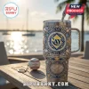 Tampa Bay Rays stainless steel tumbler featuring baseball motifs, team logo, and Tropicana Field engraving on a wood table.!