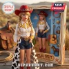 Taylor Swift doll in cowgirl outfit with blonde braids, red hat, and cow-print chaps next to boxed accessory collection.!