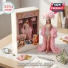 Taylor Swift inspired collectible doll in a pink feathered costume with a matching illustrated display box and accessories.!
