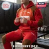 The Dolphins NRL Red Brown Pullover Hoodie and Joggers Set worn by a man in a locker room with red and brown accents.