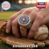Toronto Blue Jays Engraved Championship Ring featuring blue, red, and white enamel with crystals worn on a baseball glove.