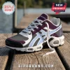 WNBA Toronto Tempo athletic sneaker with purple, white, and grey mesh upper on a wooden dock background.!