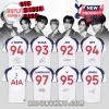 White Tottenham Hotspur soccer jerseys featuring names, birth years, and signatures of BTS members on a studio background.!