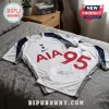 White Tottenham Hotspur soccer jersey with AIA sponsor logo, number 95, and athlete signature on a grey bedspread.!