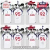 White Tottenham Hotspur soccer jerseys with BTS member names, jersey numbers, and replica signatures on back panels.!