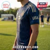 Navy blue soccer jersey with gold eagle graphic, USA text on sleeve, American flag patch, and gold shoulder stripes.!