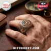 US Marine Corps Semper Fidelis Veteran Ring with eagle, globe, and anchor emblem on a hand against a wooden background.