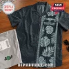 Black tropical print button-down shirt with U.S. Submarine Force insignia and Run Silent, Run Deep text on wooden table.!