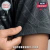 Close-up of a black tropical print shirt with palm leaf patterns and Bipu Bunny branding logo on fabric.!