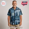 Man wearing a navy blue button-down shirt featuring US Navy submarine illustrations, radar patterns, and anchor graphics.!