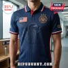 Navy blue polo shirt with embossed eagle graphic, USA flag patch, and gold United States Soccer emblem.!