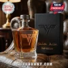 Van Halen whiskey decanter with gold logo and matching textured black display box sitting on a leather chair.!