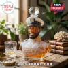 Victor Willis bust-shaped glass whiskey decanter with a sailor hat stopper, set on a wooden table with a crystal glass.!