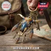 Western Bull Skull Boho Feather Keychain in metallic brass with blue and orange enamel details on a wooden surface.