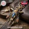Western Bull Skull Boho Feather Keychain in gold, blue, and orange hanging from a brown leather bag strap.