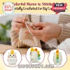 Handmade cream-colored crochet unicorn toy with a multi-colored mane and horn held by hands knitting white yarn.!