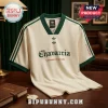 Off-white vintage style soccer jersey with dark green trim, Chavarria text, and Adidas clover logos on a wooden table.!